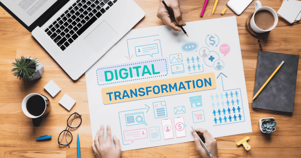 Digital Transformation shown by person working on a table with their hands writing out the concepts